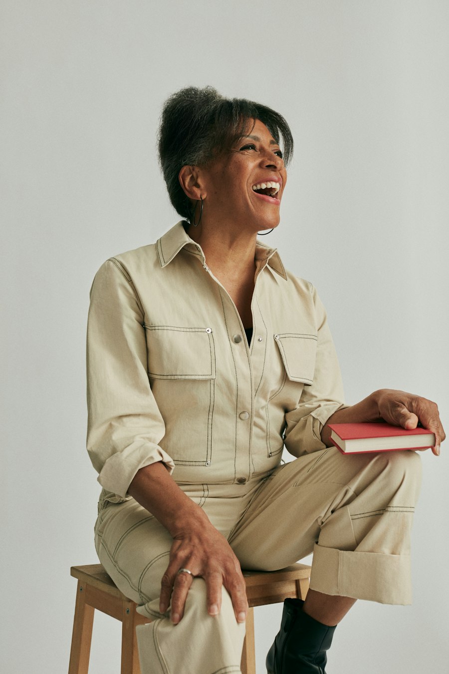 Woman laughing, holding a book