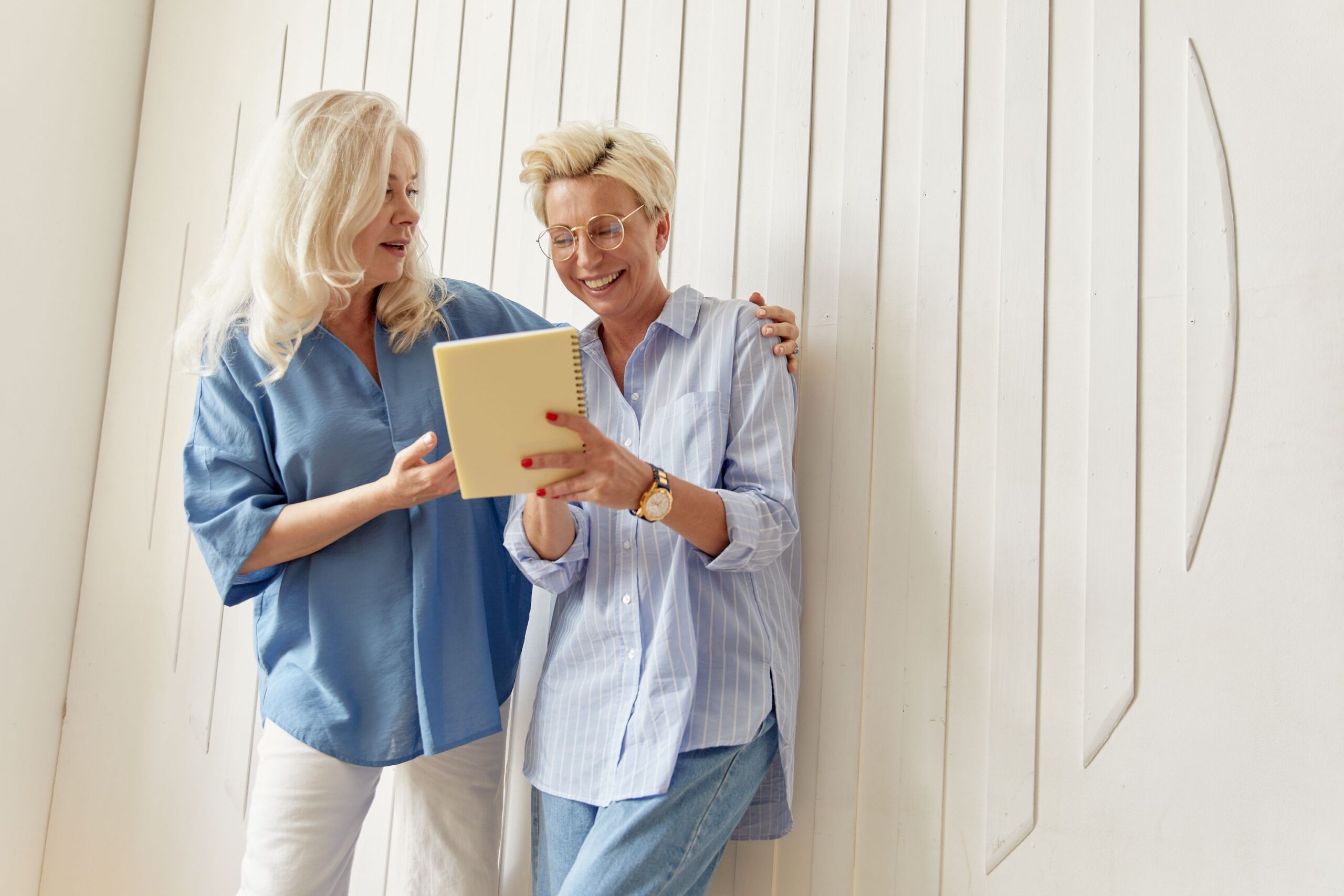 Two women talking and laughing indoors