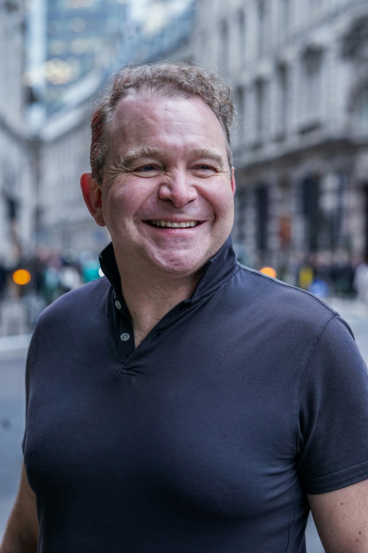 Man smiling on a city street