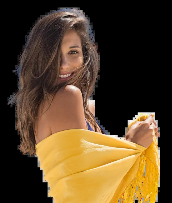 Smiling woman wrapped in a yellow scarf.