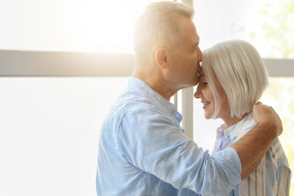 Mature couple sharing a tender moment in warm natural light