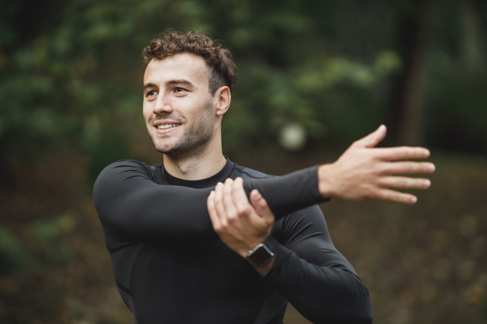 Man stretching before a workout outdoors