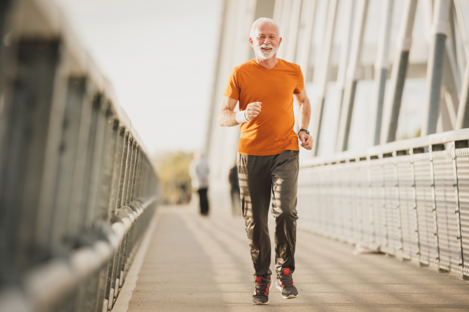 Active man running outdoors on a bridge