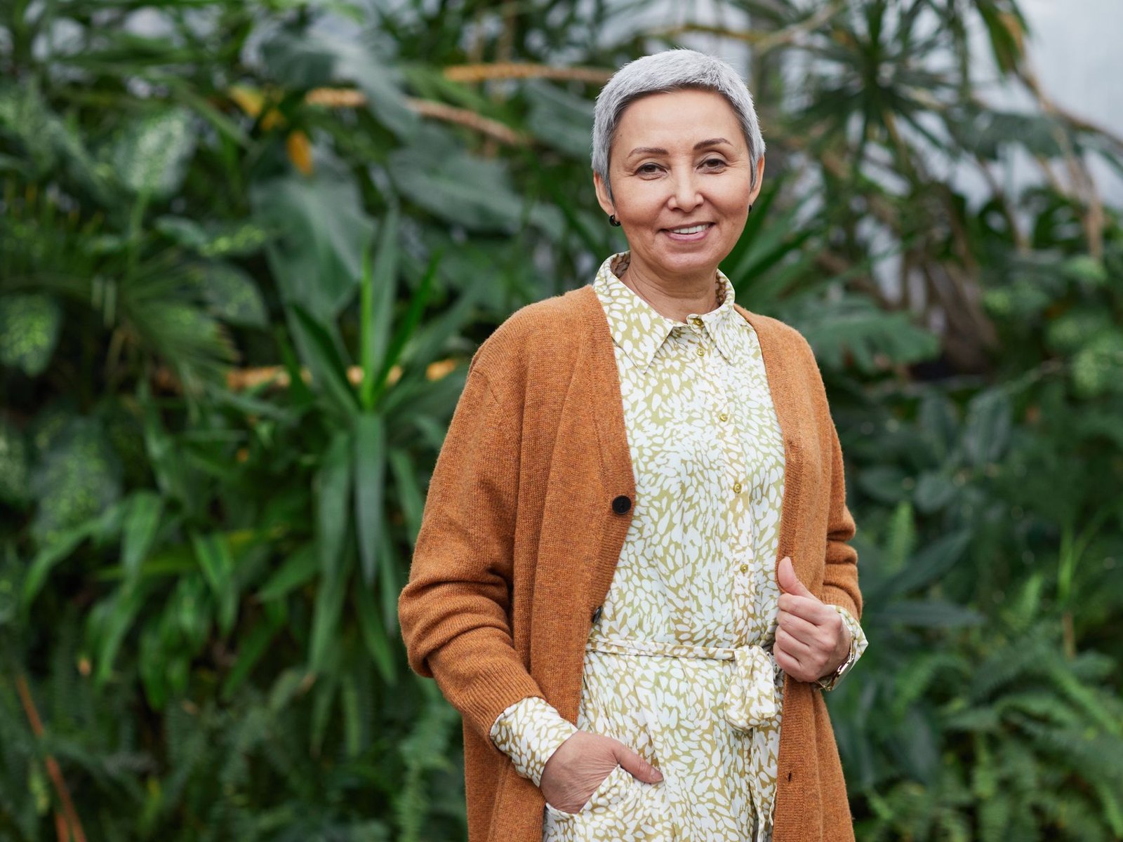 Mature woman standing among greenery
